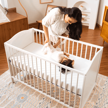 Mother placing baby in a crib with Sonno hypoallergenic baby mattress in Malaysia, providing safe and firm sleep support.