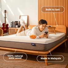 Man relaxing on Sonno bed frame made from 100% natural solid wood, built to last and made in Malaysia.