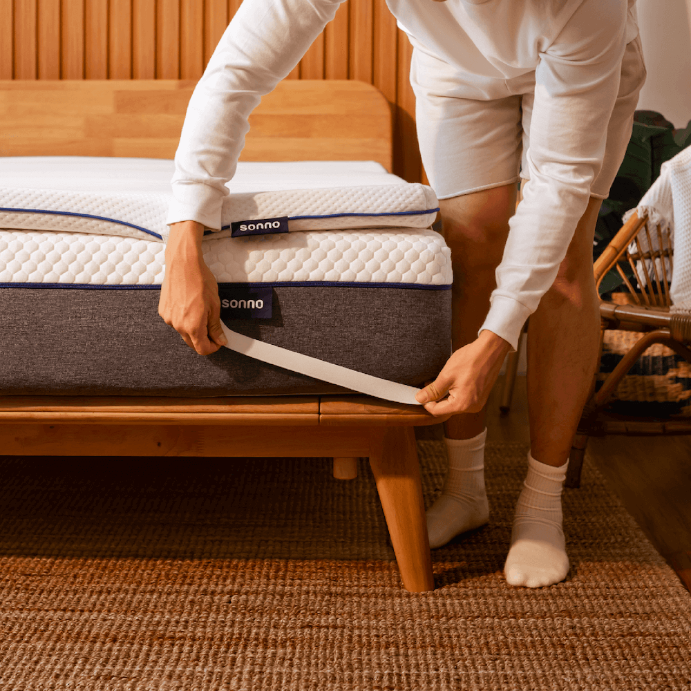 Sonno mattress topper with adjustable straps for a secure fit on the bed, providing additional comfort and support.