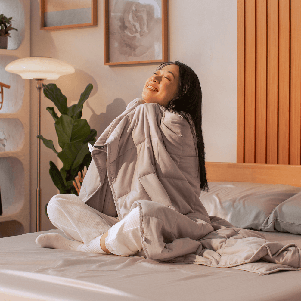 Woman feeling the calming and soothing effects of Sonno weighted blanket, recommended for better sleep and stress relief.