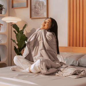 Woman feeling the calming and soothing effects of Sonno weighted blanket, recommended for better sleep and stress relief.